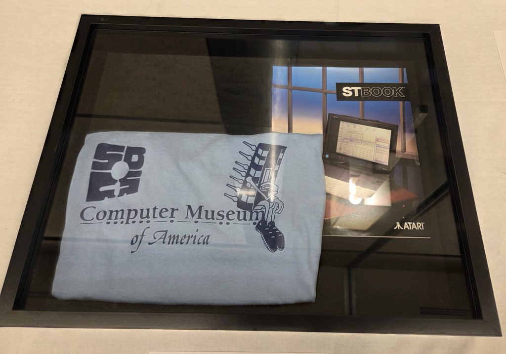 A CMA t-shirt and an Atari brochure on display at VCF SoCal 2026