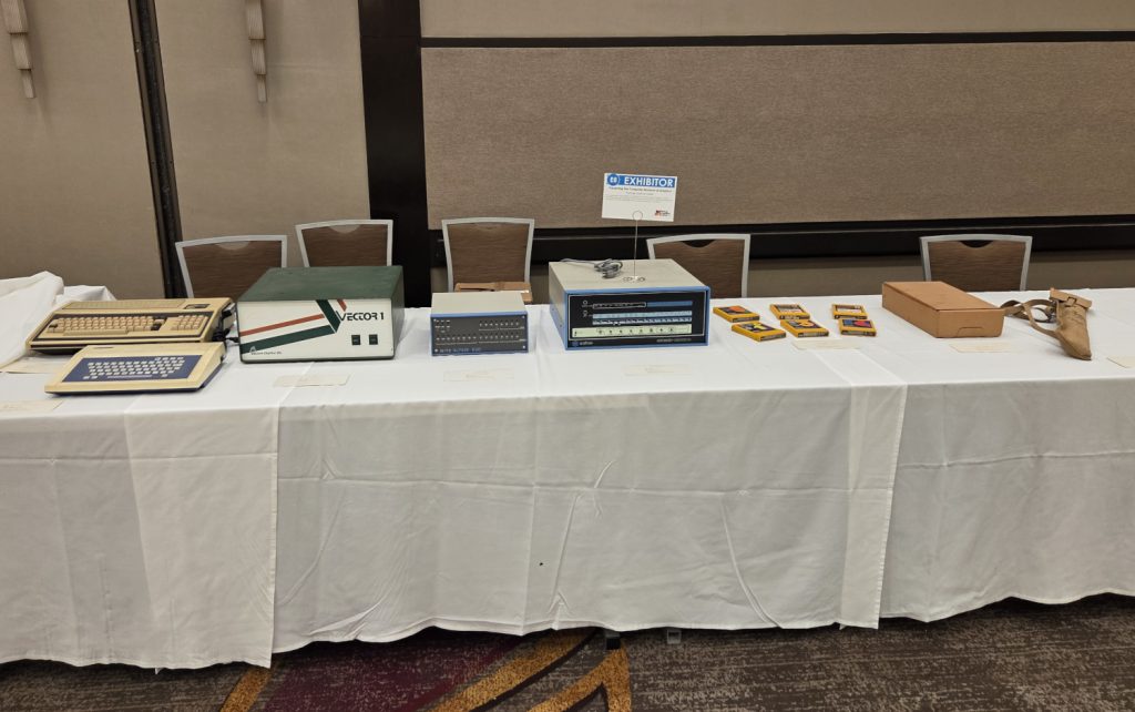 An Exidy Sorcerer, Tomy Tutor, Vector I, MITS Altair 680, an Altair 8800B, carts from a Fairchild Channel F, a carton of punch cards, and a World I U.S. army signal flag set