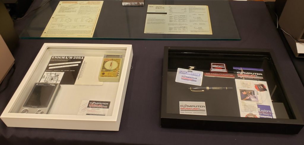 A Casio PDA (personal digital assistant) from the 1990s, and some postcards and brochures and other memorabilia from the CMA campus in downtown San Diego. Also shown on the left in the white shadowbox is an early digital multimeter from Nonlinear Systems - the company that later became Kaypro.